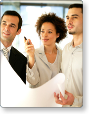 Three people looking at some type of document.