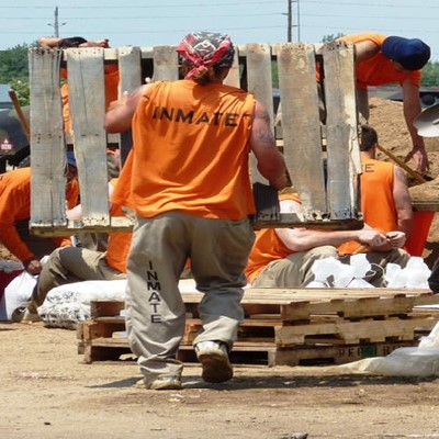 Inmates fill sandbags to be used by residents in an effort to protect their homes from flooding from the Missouri River.