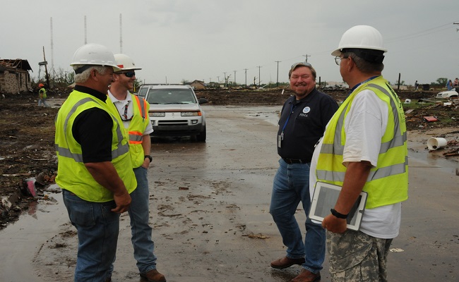 FEMA Debris Deputy Task Force Leader speaks with US Corps of Engineers Debris Subject Matter Expert and debris contractors.