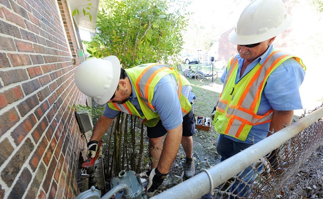Workers replace meters that were damaged by Hurricane Matthew.
