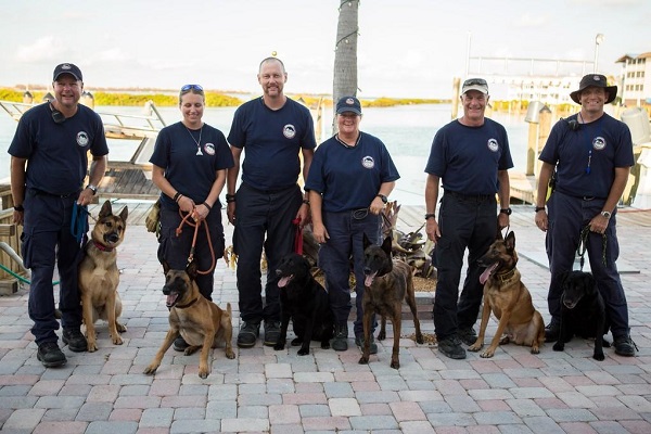 FEMA USAR Task Force 1 Canine Team enjoys a rare moment to rest and hydrate their team of rescue dogs after a relentless search for survivors oh Hurricane Irma.