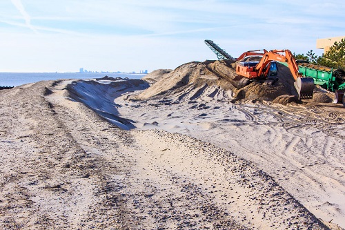 Heavy equipment rebuilding a beach on Long Island.