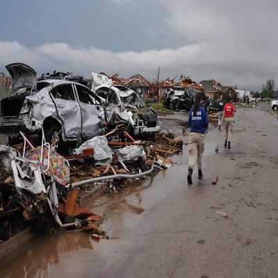 FEMA Staff and FEMA Corps members walking through a disaster site.