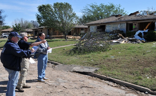 Members of the joint federal/state Preliminary Damage Assessment team looking at the damages in a neighborhood affected by the fertilizer plant explosion.