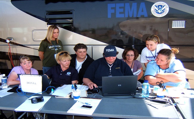 FEMA personnel review information on the computer at an incident.