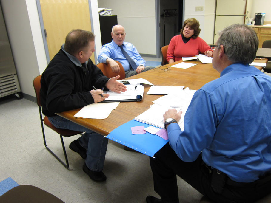 A FEMA Program Delivery Manager reviews Public Assistance guidelines with North Central District Health Department officials.