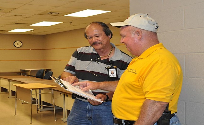 Information Technology Specialist discusses the opening of the Lauderdale County Disaster Recovery Center with County Emergency Manager.