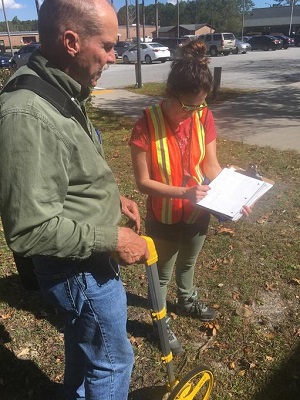 FEMA Public Assistance site inspectors take measurements of a library damaged by Hurricane Irma.