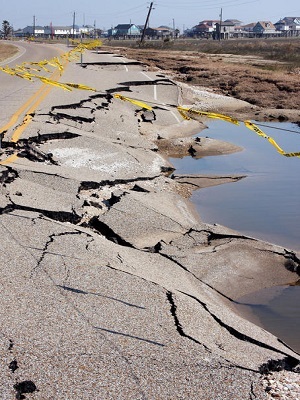 A damaged road due to surface water flooding.