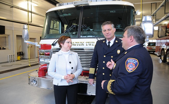 Two fire chiefs having a discussion at a fire station.