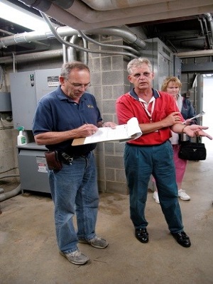 FEMA Site Inspector working on a Site Inspection Report with an Applicant.