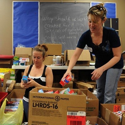 Volunteers separate items at the First Baptist Church where residents impacted by the recent tornado can come to get supplies.