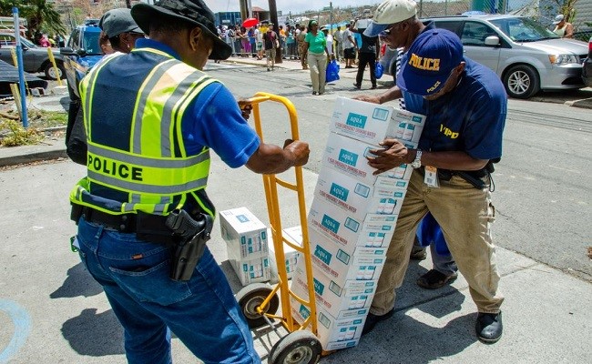 Members of the Virgin Islands Police Department in Cruz Bay help distribute water to survivors ten days after the island was devastated by Hurricane Irma, a Category 5 storm.