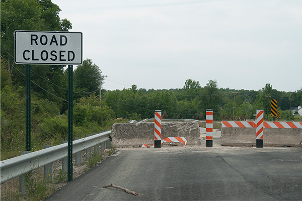 A road is closed after flood waters washed away parts of the foundation.