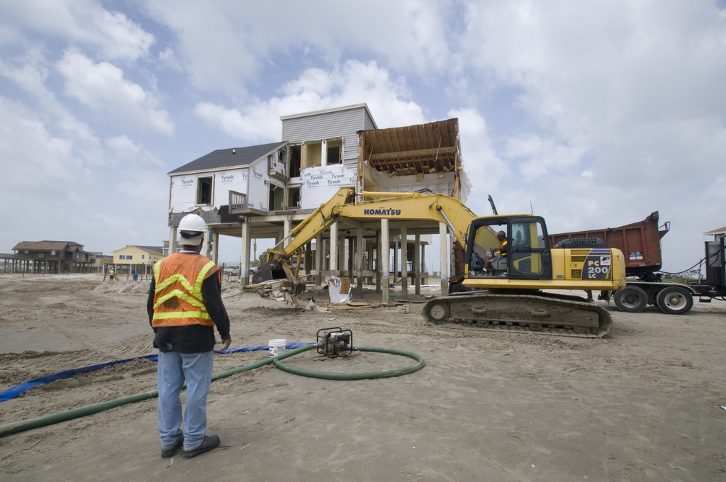 Workers preparing a structure for demolition in Texas.