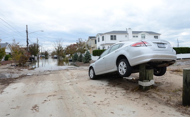 Storm surge moved inland up streets and destroyed roads and vehicles in its path.