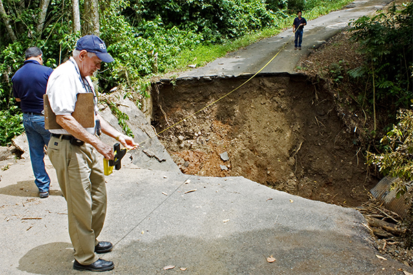 A member of Public Assistance participates in a preliminary damage assessment in the municipality of Barranquitas. The severe storms and flooding swept away roads and bridges.