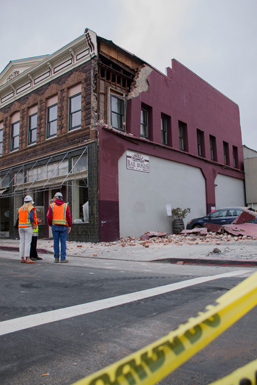 Building inspectors assess a building damaged by the earthquake that struck Napa on August 24, 2014.