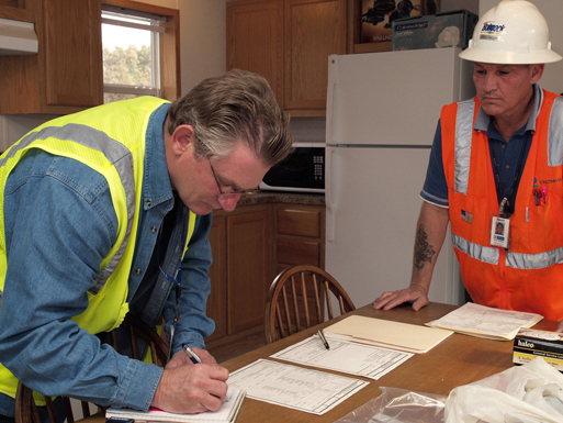 A contractor signing paperwork.