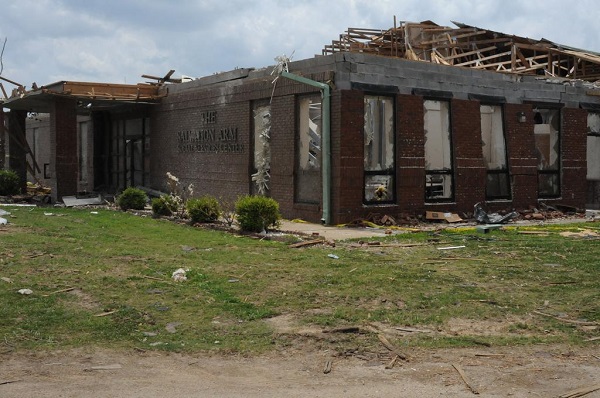 A Salvation Army Disaster Services building with heavy damage to its roof.