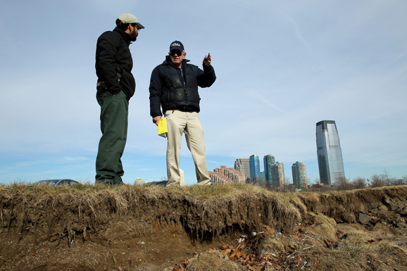 A Mitigation Specialist discusses erosion to the Liberty State Park coastline with the Park Superintendent.