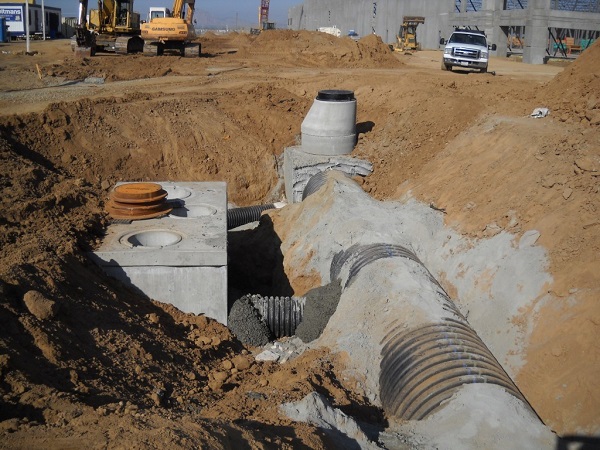 Underground pipes being installed with pressure-relief vents to the surface.