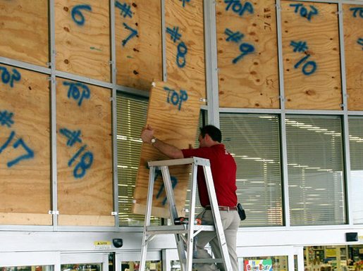 Numbered plywood panels are secured in place to protect the store front windows as merchants make preparations for Hurricane Rita's arrival.