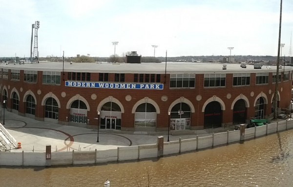 A building that says "Modern Woodman Park" with a floodwall surrounded by water.