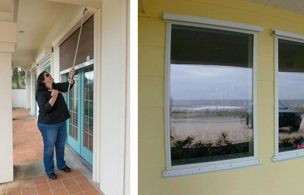 A woman rolling down a hurricane shutter over a pair of French doors. A row of new windows in a beach-front building.