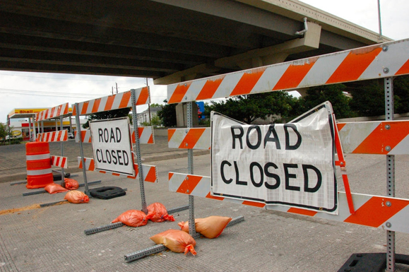 Several Road Closed barricades block Highway 6 in Houston.