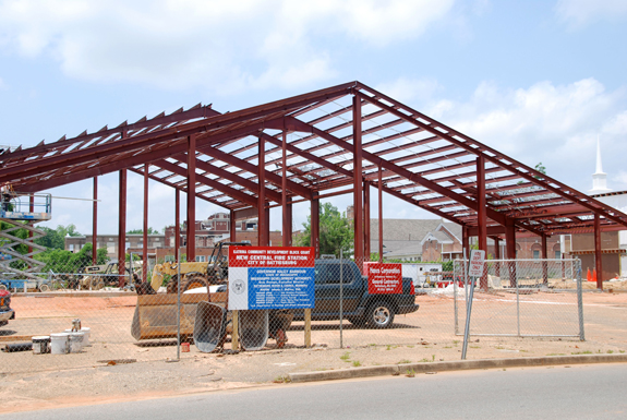 Construction crews work on the frame of a new building