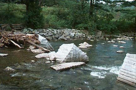 Granite blocks in a river retain ice and reduce risk of flooding with minimal disruption of the natural environment.