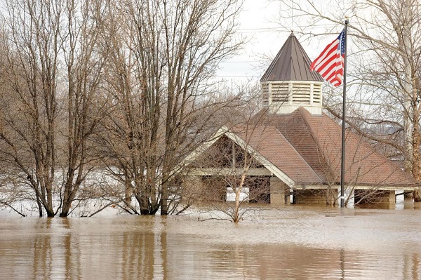 Flood waters rising nearly to the roof of a historic park structure.