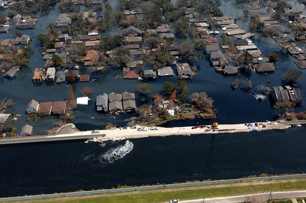 A New Orleans neighborhood flooded by Hurricane Katrina. Crews work on areas where there have been breaks in the levee in order to avoid additional flooding.