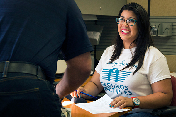 An insurance company employee smiling at a survivor that she is helping