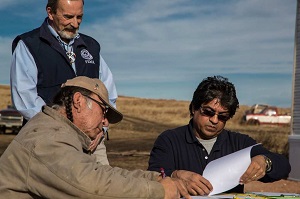 FEMA FCO and FEMA Case Worker complete final paperwork to turn over a FEMA Manufactured Housing Unit to an Oglala Sioux Tribal member following a disaster on the Pine Ridge Reservation in SD.