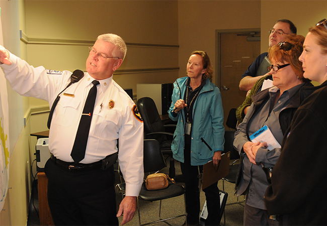 A FEMA team member meets with local Emergency officials to determine eligibility