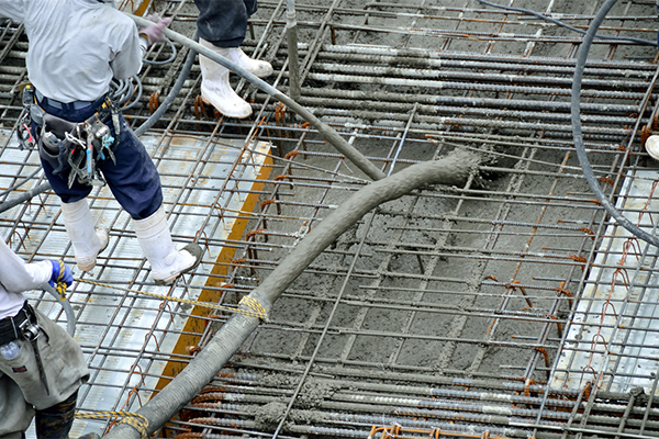 Construction workers pouring concrete