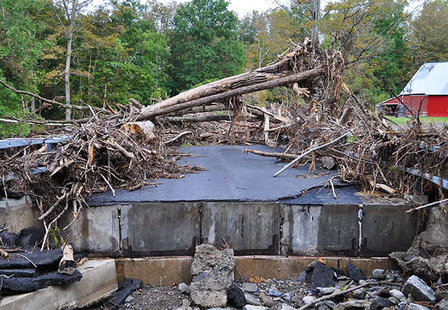 A heavily damaged bridge covered with debris from Hurricane Irene.