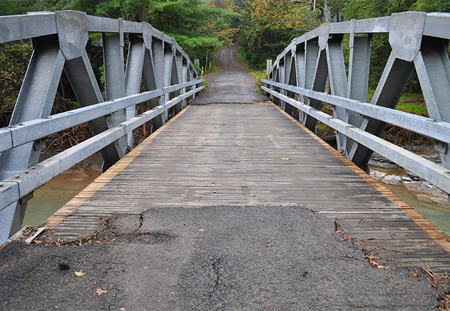 Damaged bridge from Hurricane Irene that is missing asphalt.