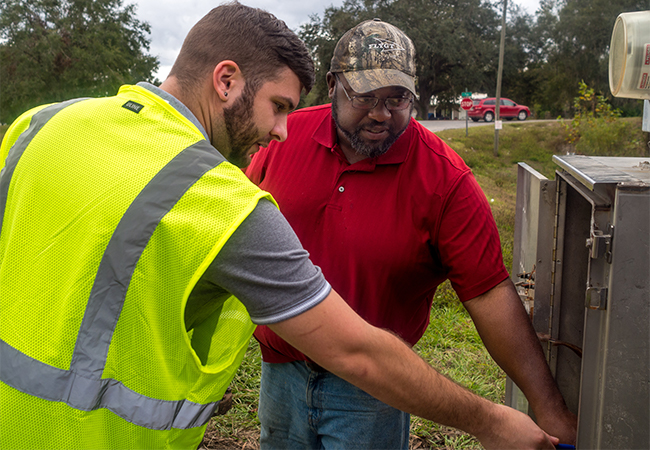 Two members of a Public Assistance crew performing a site inspection