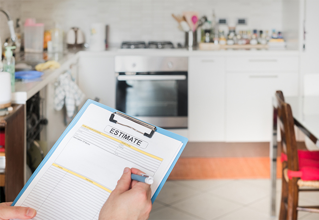 Document on a clipboard labeled "Estimate" with a kitchen in the background