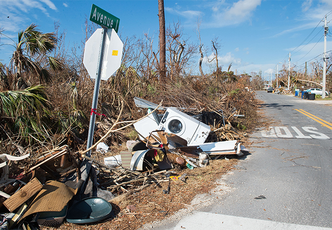 Debris sitting on the side of the road next to a stop sign