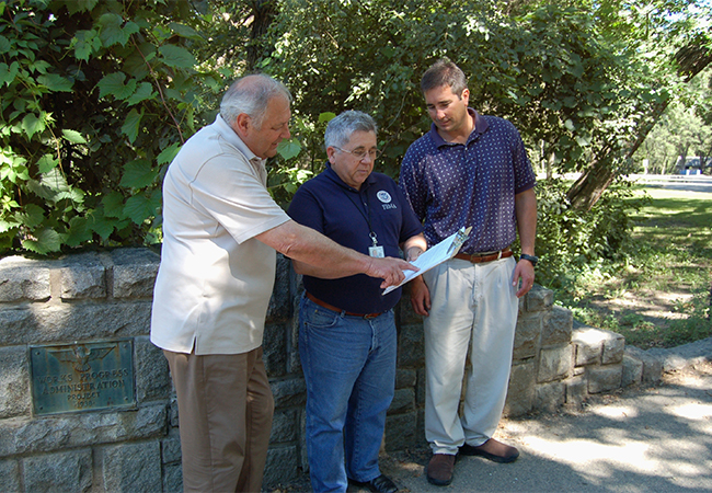 FEMA EHP team lead discussing requirements with two officials