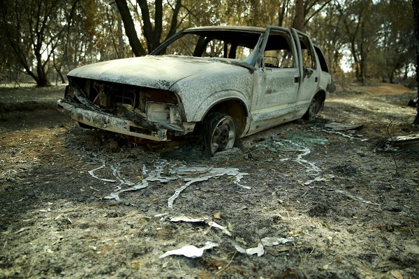 A badly-burned car with a melted engine