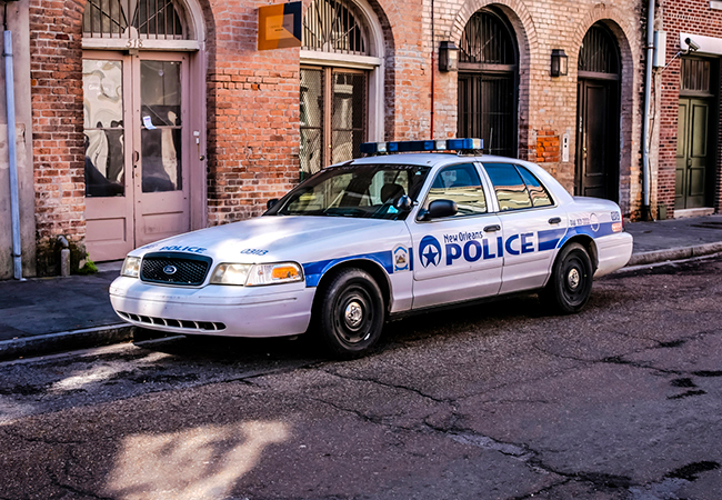 New Orleans Police Squad Car in front of a building
