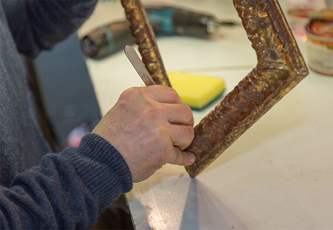 Craftsman working on wooden vintage frame