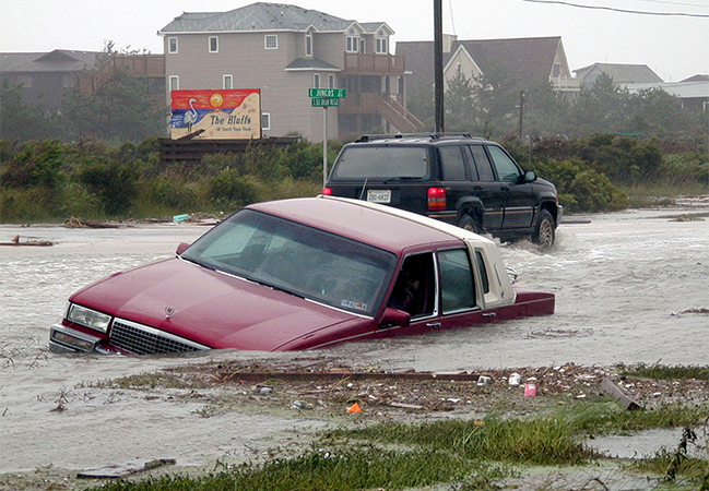 Abandoned vehicle flooded on the road