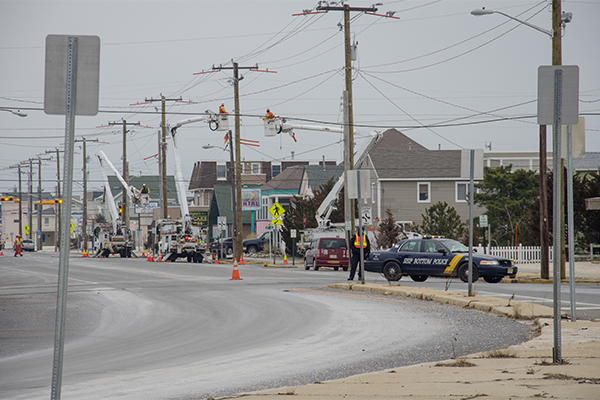 This barrier island was devastated by Hurricane Sandy three months ago. Crews are now replacing all of the utility poles and wires.