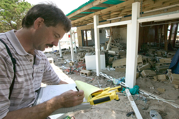 Insurance adjuster, Mike McConaghy reviews remains of home at Shell Point following Hurricane Dennis. FEMA photo/Andrea Booher Photo by Andrea Booher - Jul 17, 2005 - Location: Shell Pt., FL